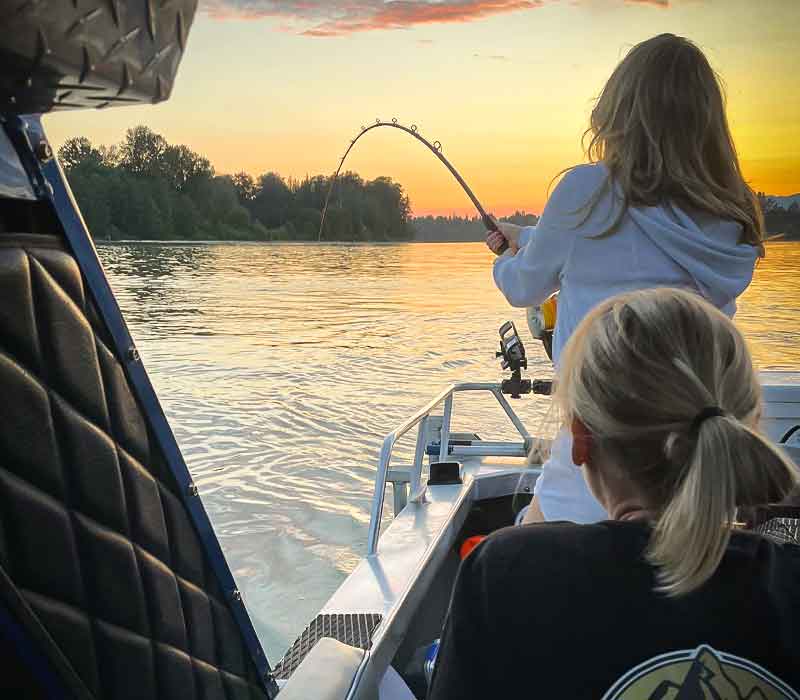 Two women enjoying some Fraser River Sturgeon Fishing in the early evening.