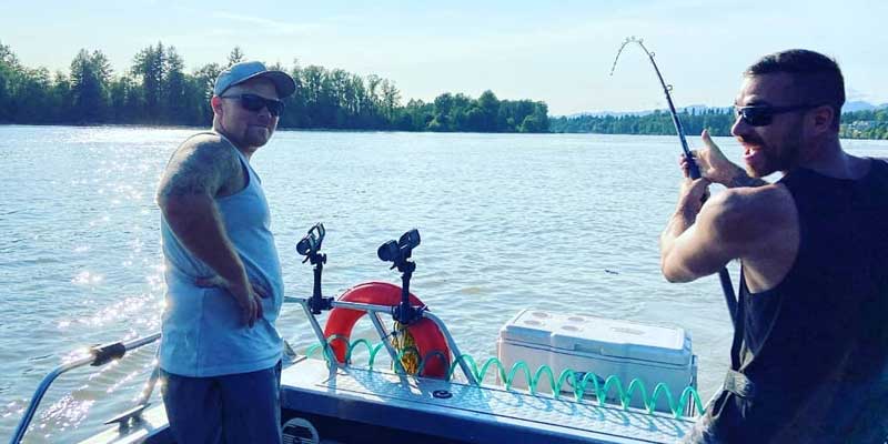 Two guys out fishing on a boat - Golden Ears Fishing Adventures